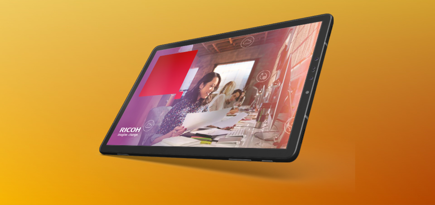 Tablet device displaying a business meeting scene with professionals reviewing documents and digital data overlays, set against a vibrant orange background with Ricoh branding.