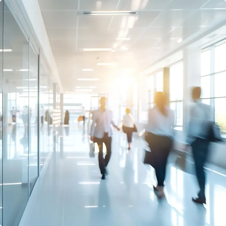 A group of people walking in a hallway