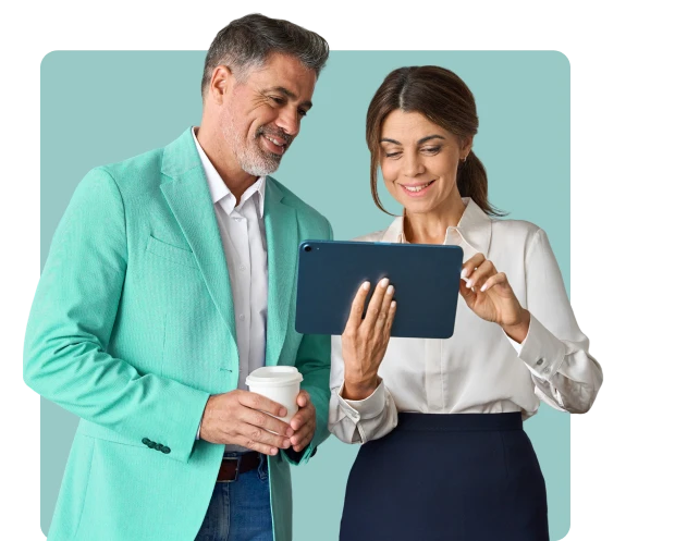 Two professionals, a man and a woman, are reviewing information on a tablet, symbolizing the streamlined process of e-invoicing and digital financial management. The man holds a coffee cup, and the woman holds the tablet.